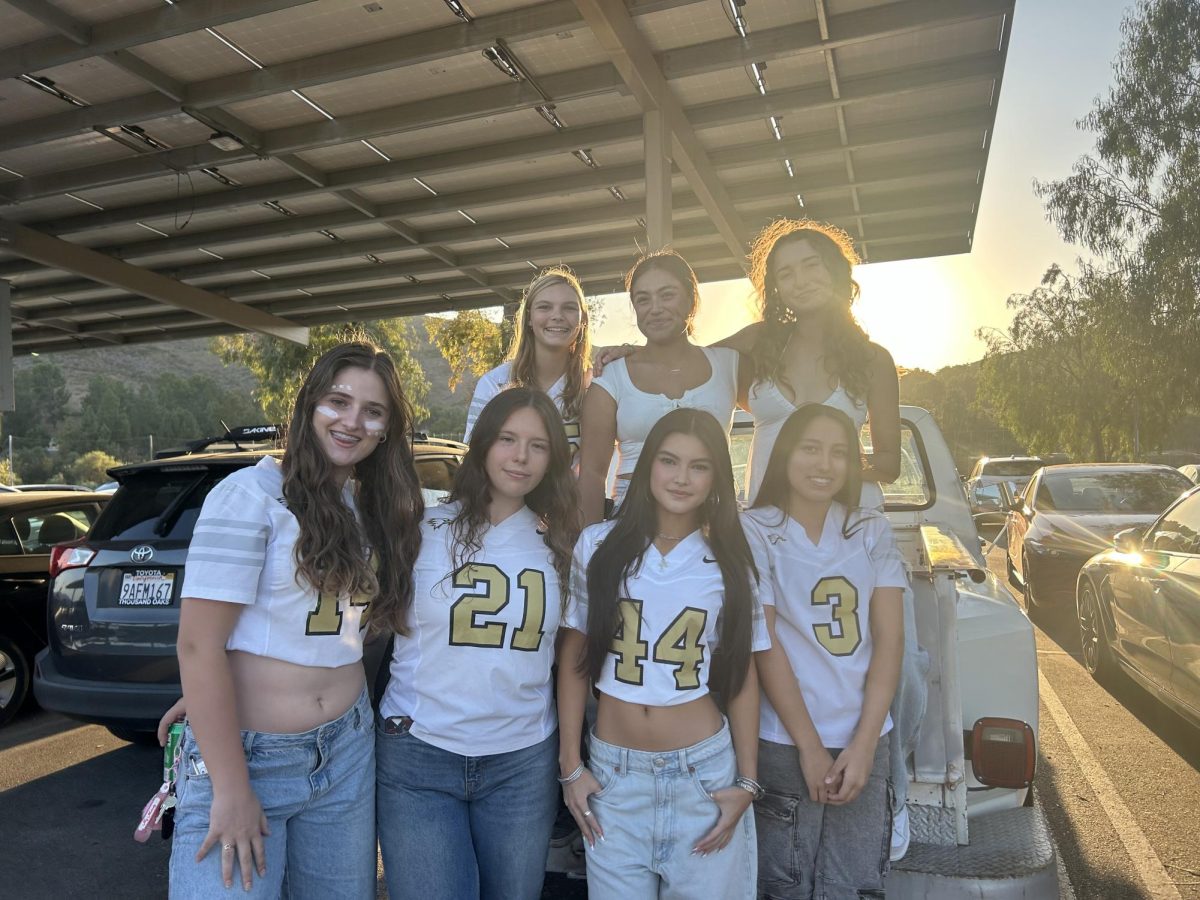 The OPHS girls flag football team gathers at the tailgate