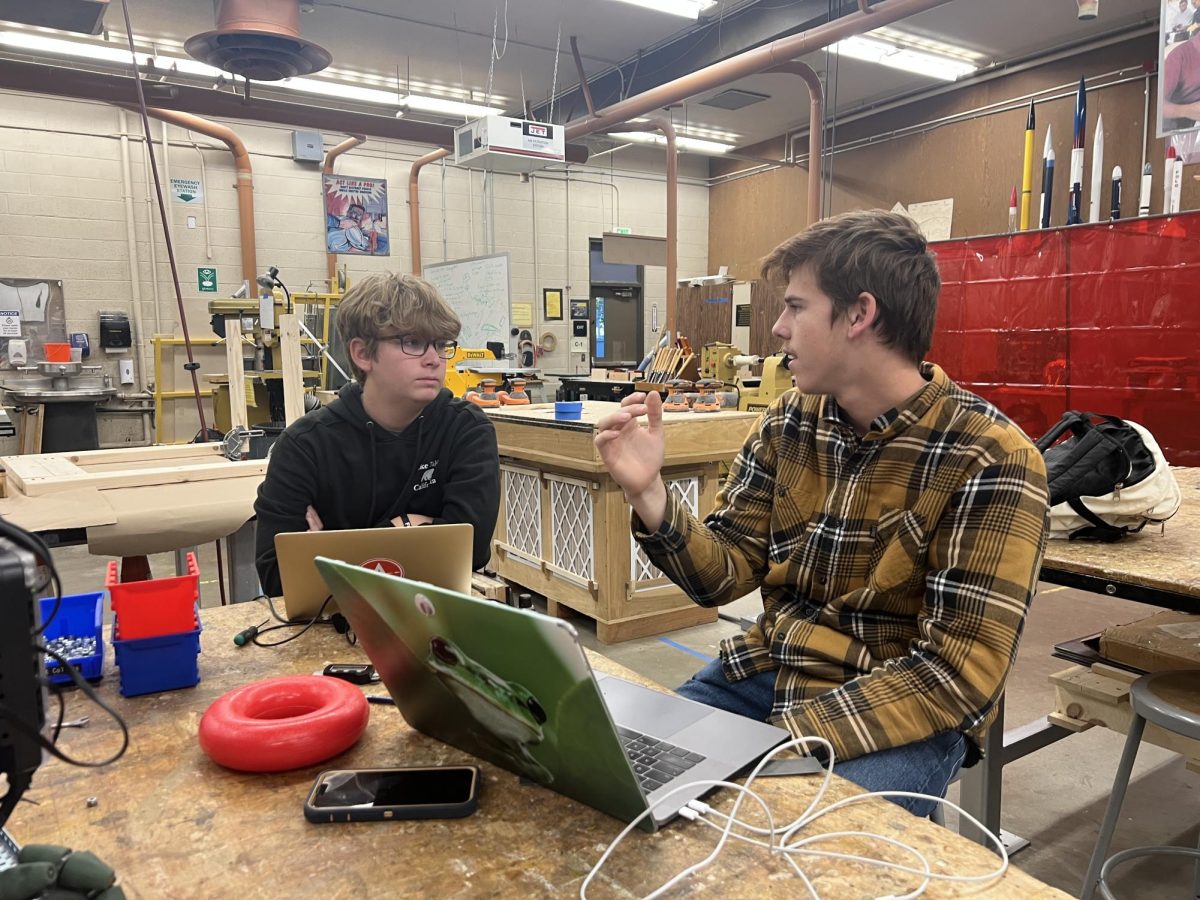 Junior Ricky Radant and sophomore Jackson Farhat work on the code for their robot.