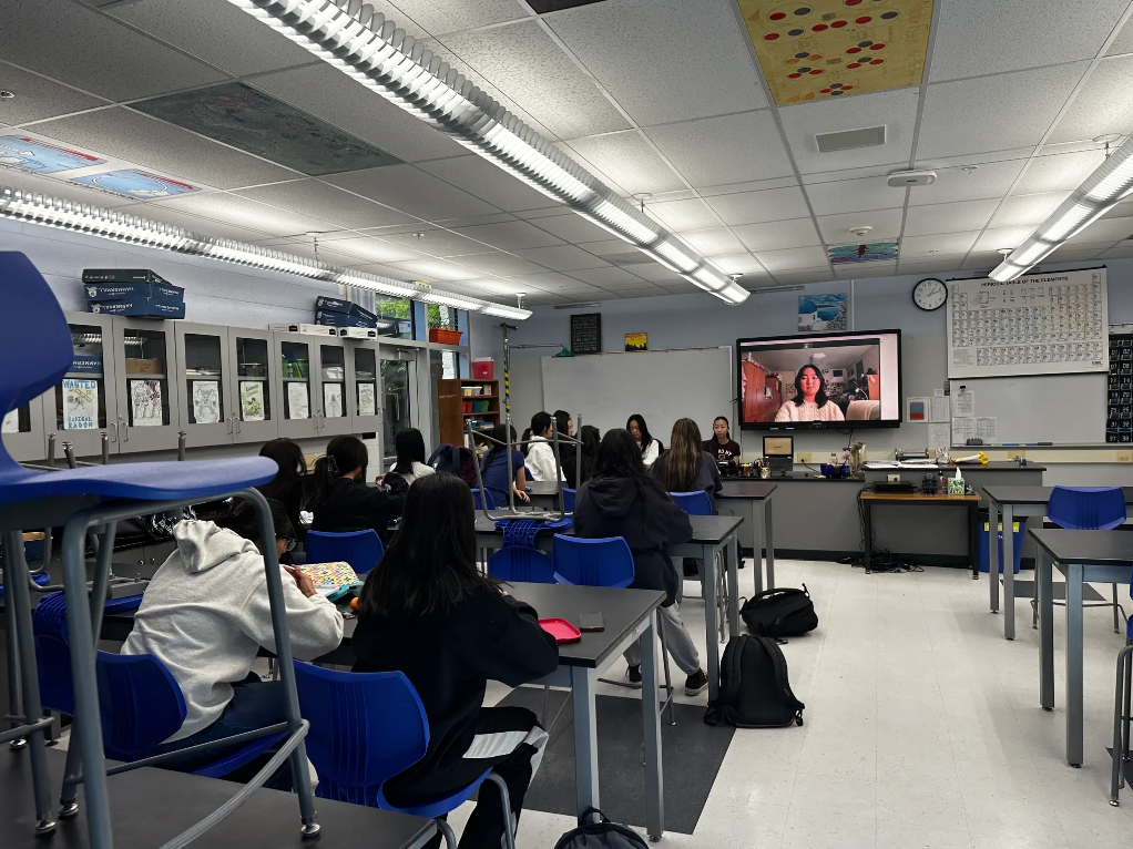 Club members listen to alumni, Michelle Bi, at a club meeting