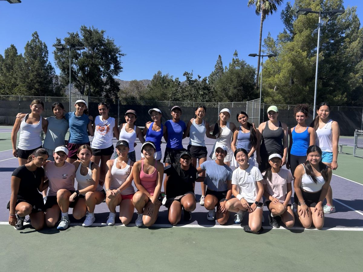 Girls' tennis team poses for a group photo.
