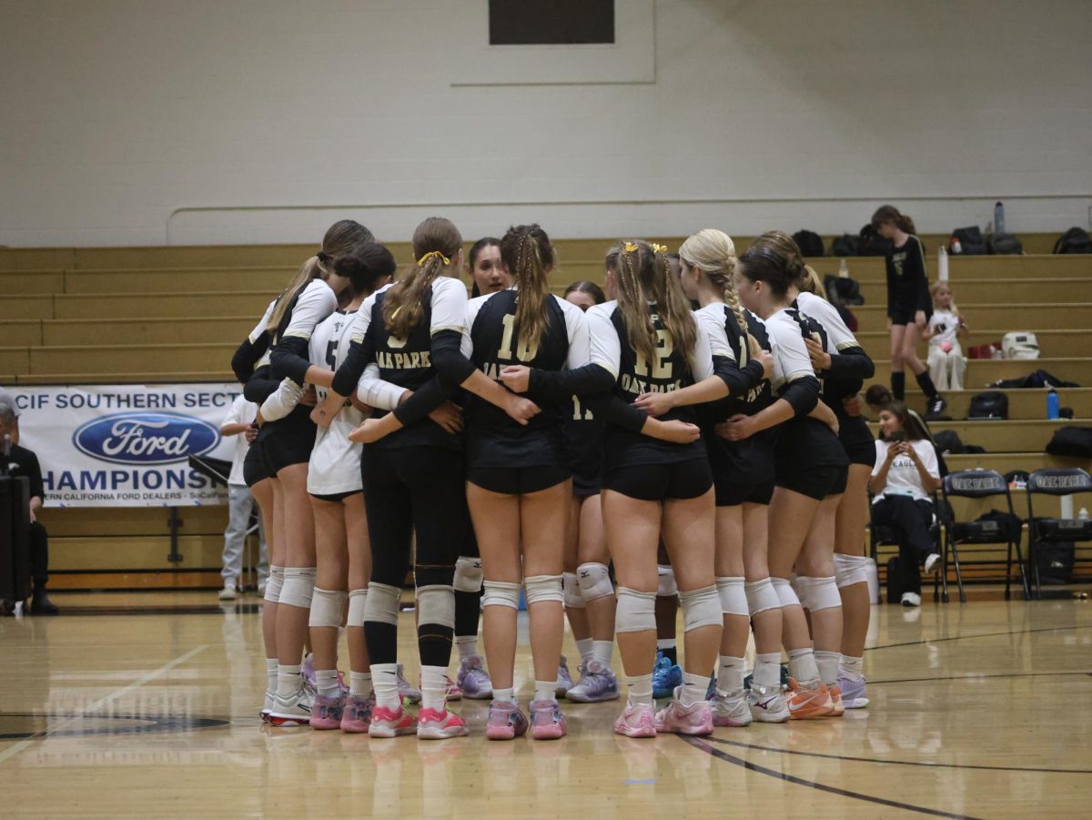 Varsity girls volleyball huddles at the OPHS home game against Hoover/Glendale on Aug 14.
