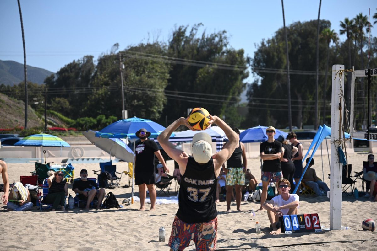 JV player Cameron McNeilly sets the ball at Marmonte Beach League Tournament #2 on Saturday, Aug, 30. (Photo by Timon Pham/OPHS Boys Beach Volleyball)