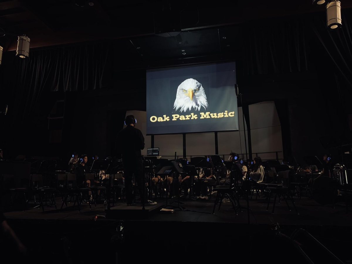 Zachary Borquez prepares to conduct Wind Ensemble. (Photo by Daniela Trivelli/Oak Park Music)
