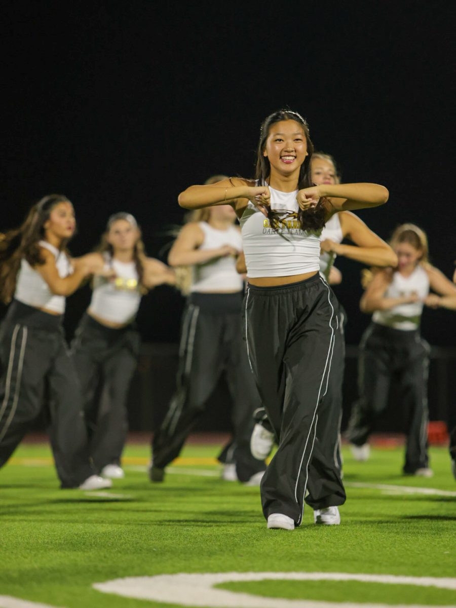 Chung dances under the floodlights at halftime.